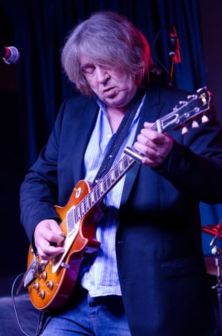 Mick Taylor playing guitar at Iridium in New York in 2012