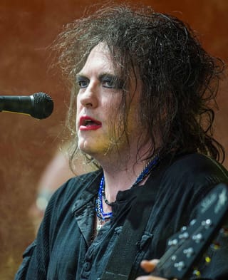 Robert Smith on stage with the Cure at Roskilde Festival in 2012